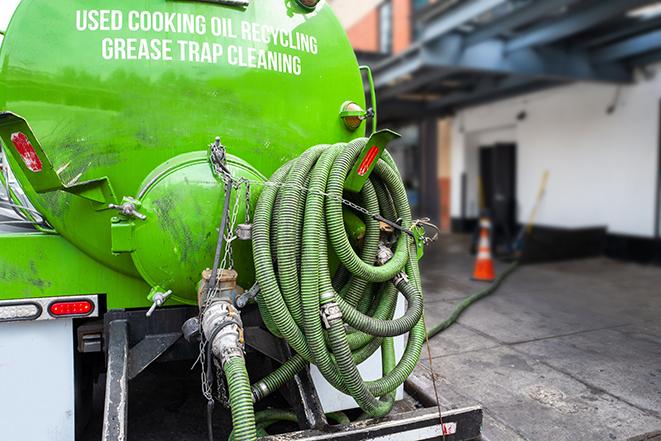 large truck pumping grease trap at a restaurant in Clearwater Beach